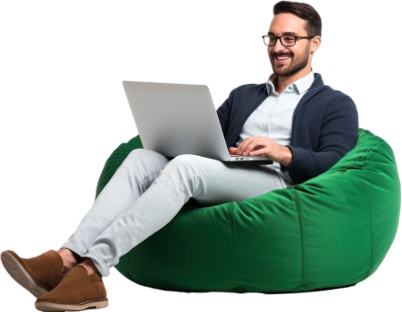 cheerful-man-working-laptop-seated-green-beanbag